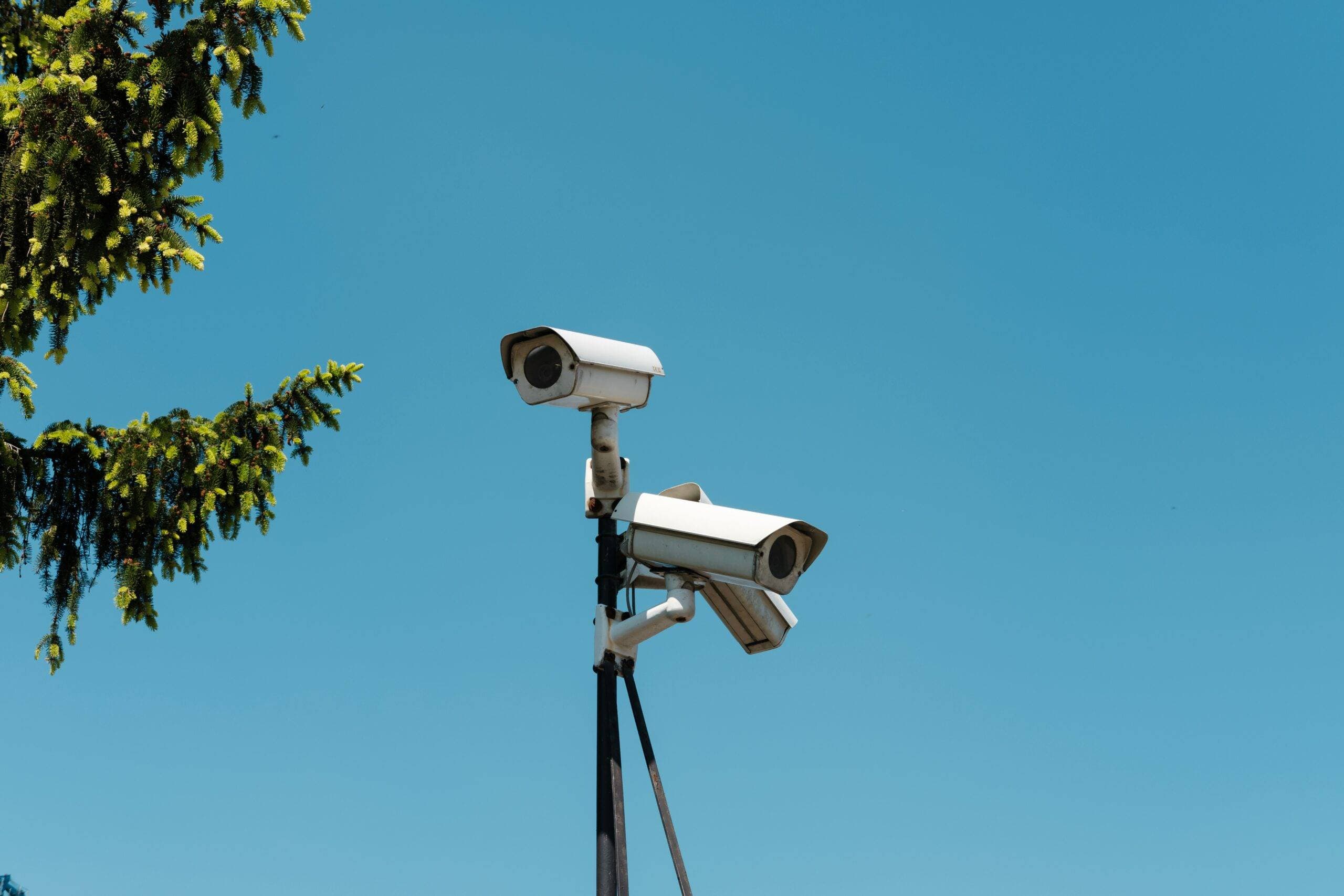 Mounted surveillance camera overlooking an outdoor area